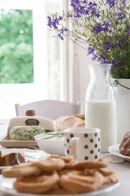 a table with a plate of food and a jug of milk at Domeček na Květinovém statku in Zdice