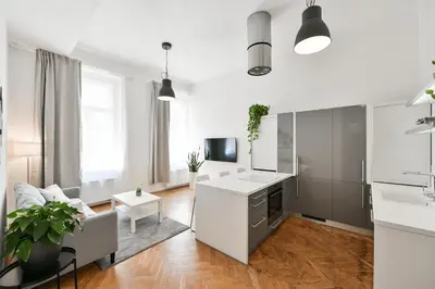 a white living room with a couch and a table at Klimentská 52 Residence in Prague