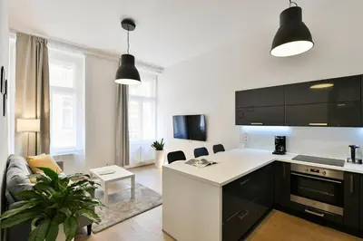 a kitchen and living room with a couch and a table at Klimentská 52 Residence in Prague