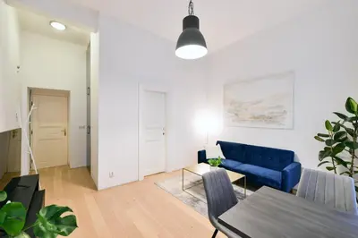a living room with a blue couch and a table at Klimentská 52 Residence in Prague