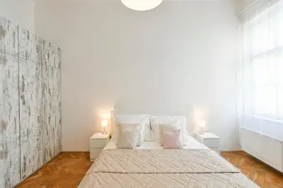 a bedroom with a large bed with two night stands at Klimentská 52 Residence in Prague