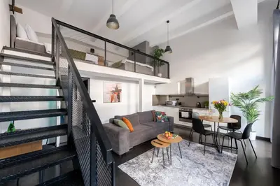 a living room with a couch and a table at Loft spacious apartments in Prague in Prague