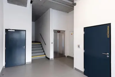 a hallway with two blue doors and a staircase at Loft spacious apartments in Prague in Prague