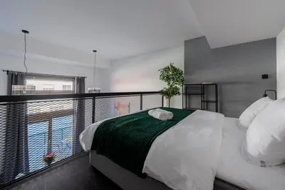 a bedroom with a large bed on a balcony at Loft spacious apartments in Prague in Prague