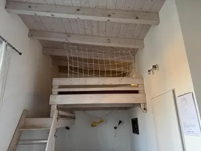 a staircase in a room with a wooden ceiling at DIVADELNÍ PENZION in Bukovany