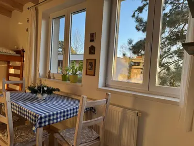a table and chairs in a room with windows at DIVADELNÍ PENZION in Bukovany