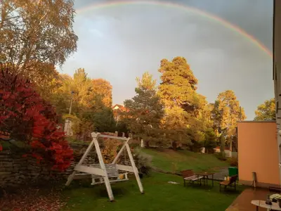 a rainbow over a yard with a swing at DIVADELNÍ PENZION in Bukovany