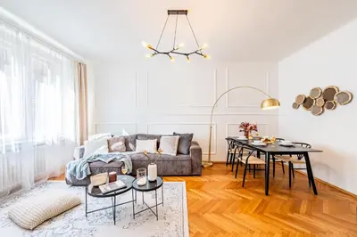 a living room with a couch and a table at Prague Days - Apartment with Balcony & Garage near Vltava River in New Town in Prague