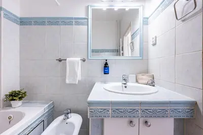 a bathroom with a sink and a tub and a mirror at Prague Days - Apartment with Balcony & Garage near Vltava River in New Town in Prague