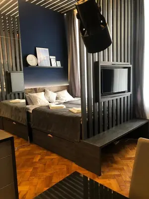 a bedroom with a bed and a tv in it at Holec Apartments in Prague