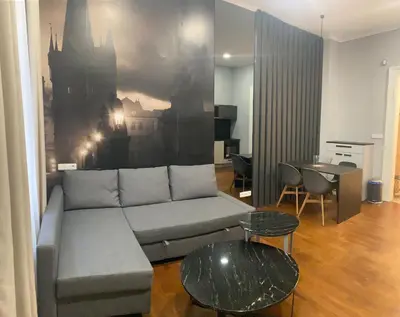 a living room with a couch and a table at Holec Apartments in Prague
