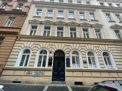 a building with a black door and windows at Holec Apartments in Prague