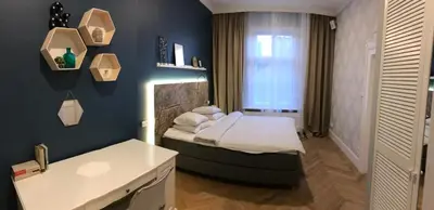 a small bedroom with a bed and a window at Holec Apartments in Prague
