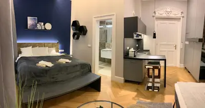 a bedroom with a bed and a desk in a room at Holec Apartments in Prague
