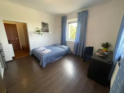 a small bedroom with a bed and a window at Báječné ubytování ve vile s bazénem a terasou v praze in Prague