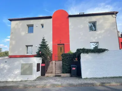 a house with a red stripe on the side of it at Báječné ubytování ve vile s bazénem a terasou v praze in Prague