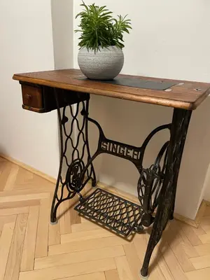 a wooden table with a potted plant on it at Apartment Garden in Prague