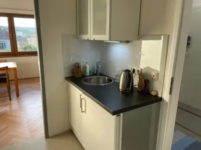 a kitchen with a sink and a counter top at Apartment Garden in Prague