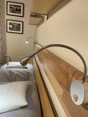 a lamp in a room with two beds at Apartment Garden in Prague