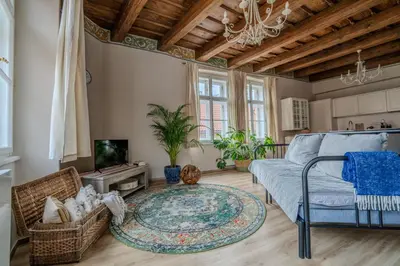 a kitchen with a dining room table and chairs at Charles Bridge Prague Apartment in Prague