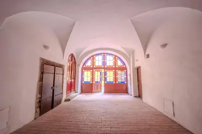 an empty hallway with a red door in a building at Charles Bridge Prague Apartment in Prague