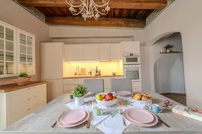 a wicker basket with white towels in it at Charles Bridge Prague Apartment in Prague