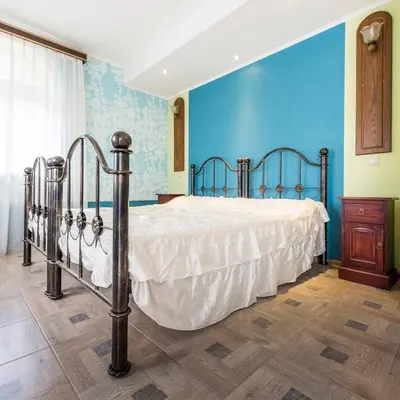a bedroom with a bed with a blue wall at Vila u Prahy,v prirode,jezero Lhota in Lhota