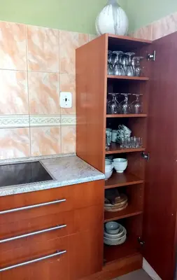 a kitchen with wooden cabinets and a sink at Vila u Prahy,v prirode,jezero Lhota in Lhota