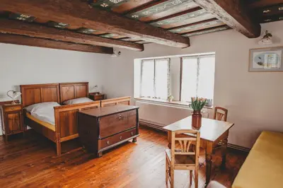 a bedroom with a bed and a table and chairs at Boutique Apartmán Speicher in Prague
