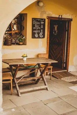 a wooden picnic table in a room with a door at Boutique Apartmán Speicher in Prague