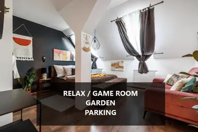 a living room with a couch and a table at Spacious flat & parking possibility, 3 stops to Wenceslav square in Prague