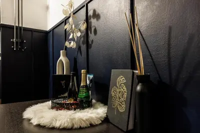 a table with bottles and vases on top of it at Spacious flat & parking possibility, 3 stops to Wenceslav square in Prague