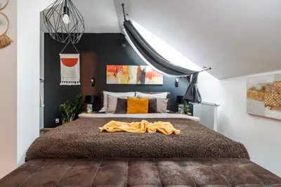 a bedroom with a bed with a blanket on it at Spacious flat & parking possibility, 3 stops to Wenceslav square in Prague