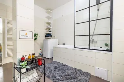 a bathroom with a tub and a window at Spacious flat & parking possibility, 3 stops to Wenceslav square in Prague