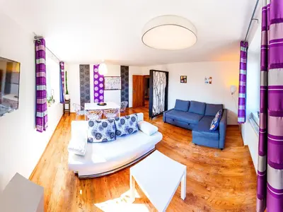 a living room with a couch and a table at Apartment Pod Sychrovem in Prague