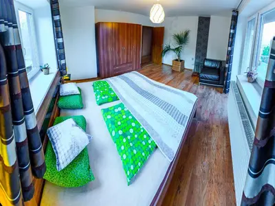 a bedroom with a bed with green ties on it at Apartment Pod Sychrovem in Prague