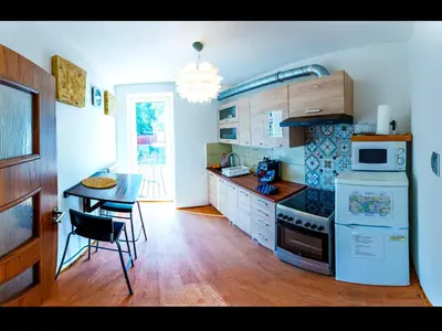a kitchen with a table and a stove top oven at Apartment Pod Sychrovem in Prague