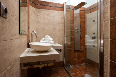 a bathroom with a sink and a shower at Sunset Apartment Prague in Prague