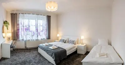a bedroom with two beds and a window at Sunset Apartment Prague in Prague
