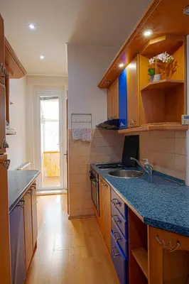 a kitchen with a sink and a blue counter top at Sunset Apartment Prague in Prague
