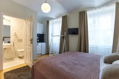 a bedroom with a bed and a bathroom at River View Residence by Charles Bridge in Prague