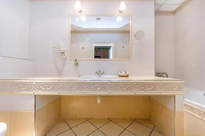 a bathroom with a sink and a mirror and a tub at River View Residence by Charles Bridge in Prague