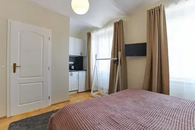 a bedroom with a bed and a window and a door at River View Residence by Charles Bridge in Prague