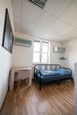a room with a bed and a table in it at Snug room close to metro Palmovka in Prague