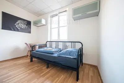 a bedroom with a bed in a room with a window at Snug room close to metro Palmovka in Prague