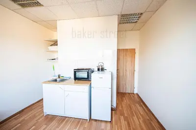 a kitchen with a refrigerator and a microwave at Snug room close to metro Palmovka in Prague