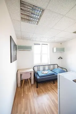 a room with two beds and a table at Snug room close to metro Palmovka in Prague