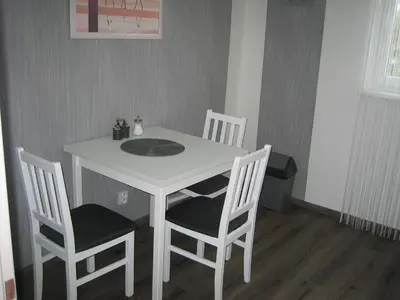a white table and chairs in a room at Apartmány Polepy in Polepy
