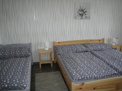 a bedroom with two beds and two night stands at Apartmány Polepy in Polepy
