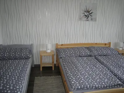a bedroom with two beds and two night stands at Apartmány Polepy in Polepy